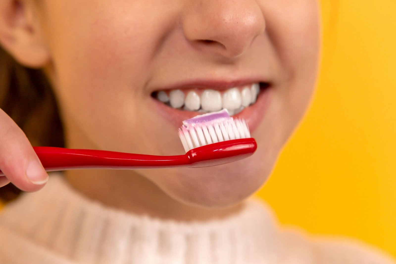 Toothbrush and healthy smile representing preventive oral care