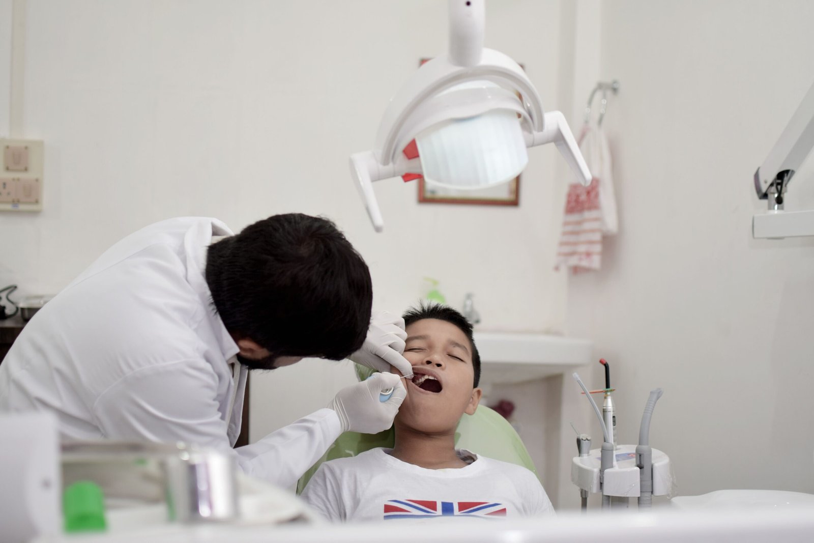 Dental professional providing preventive care to a young patient